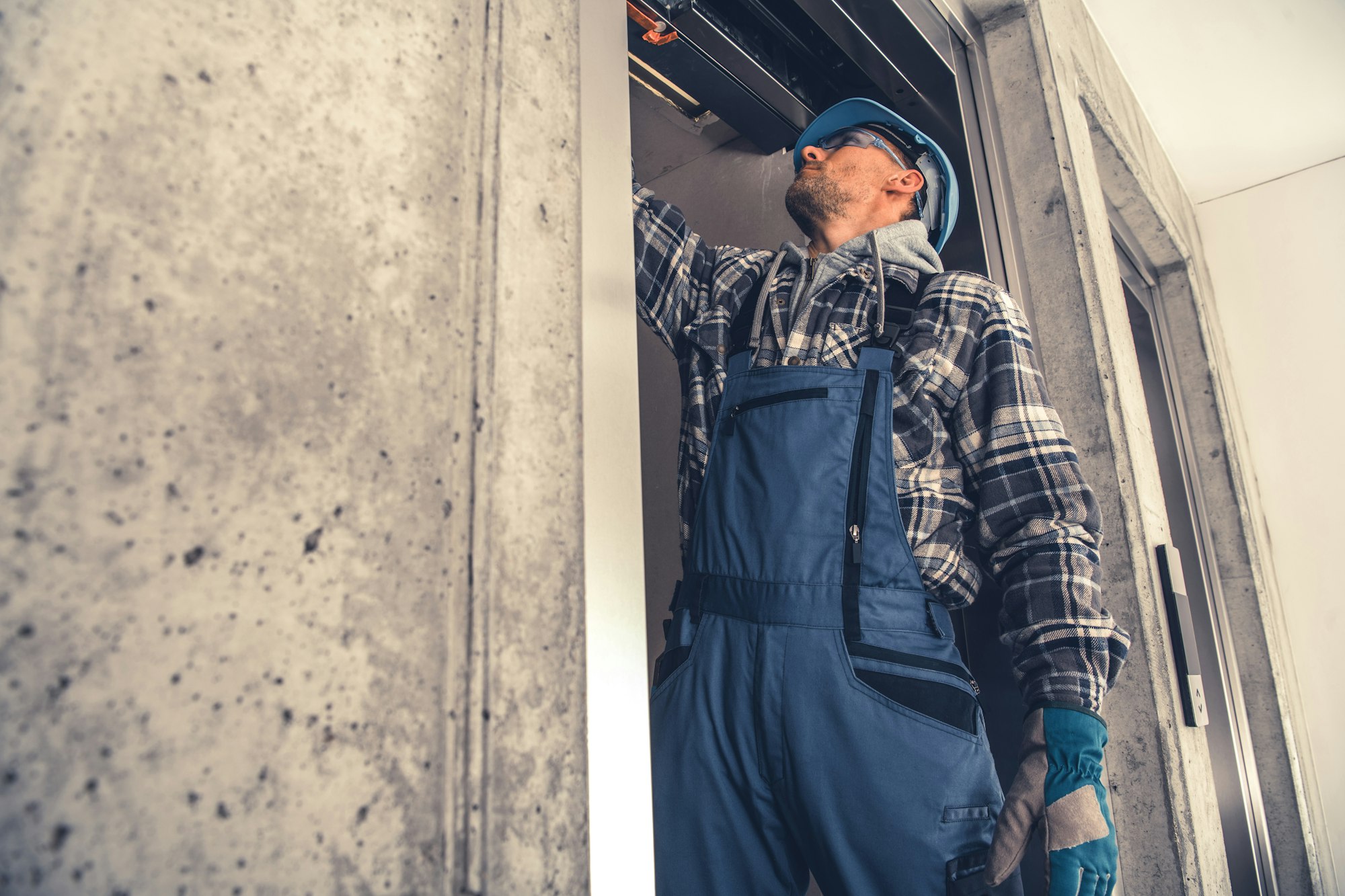 Elevator Technician Performing Scheduled Check